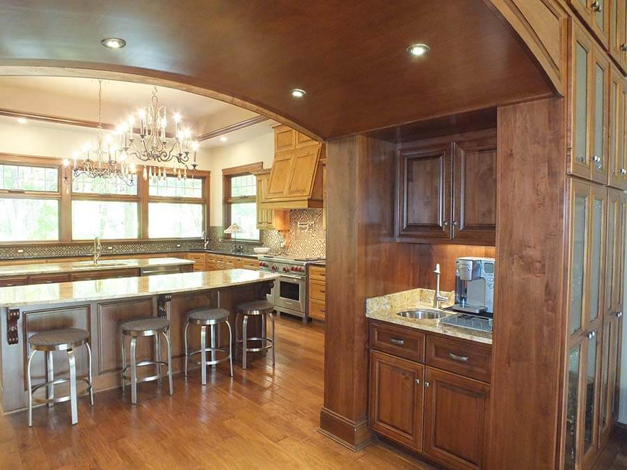 View of dining room and kitchen, featuring our beautiful brown wood cabinets