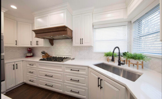 white kitchen cabinets with brown oven hood, beautifully crafted by our team