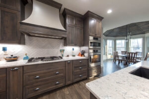 cultured neutrals kitchen cabinets dark brown, sleek, and modern
